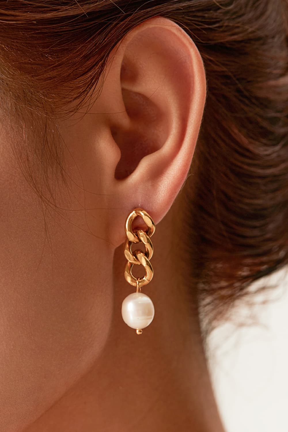 Gold pearl earrings close-up